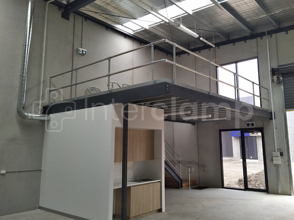 Interclamp tube and key clamp fittings used to install a balustrade for safety around a warehouse mezzanine floor and handrails for the stairs.